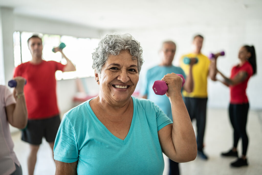 Woman lifting weights who understands physical activity vs. exercise