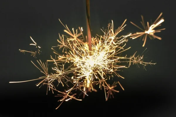 A sparkler ignites with a vibrant display of fiery streaks against a dark background, reminiscent of the energy and passion seen at the Cardiovascular Institute of the South.