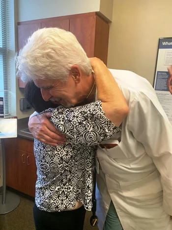 A heartfelt embrace between two people at the Cardiovascular Institute of the South, conveying a strong sense of comfort, support, or possibly a reunion.