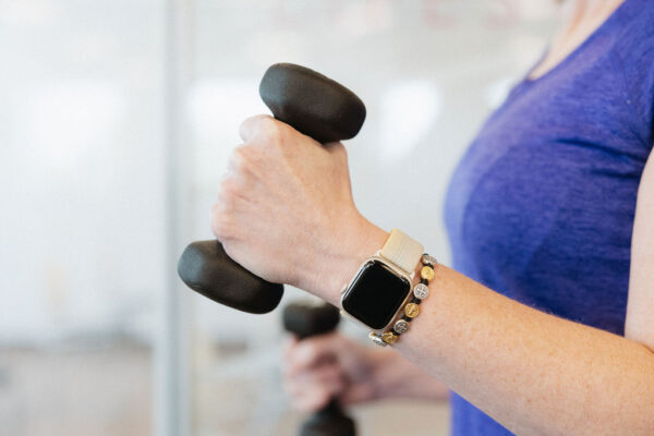 Close up of a cardiac rehab fitness instructor holding small hand weights