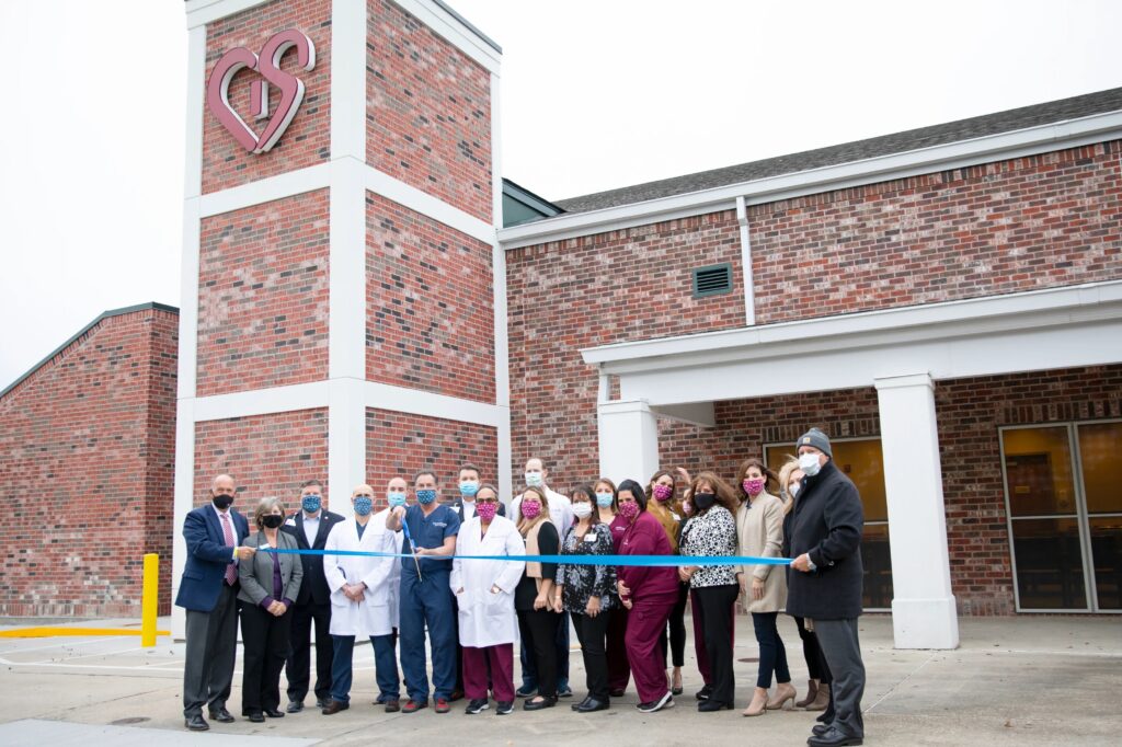 A group of CIS staff members and business people pose for the ribbon cutting of the newly renovated Thibodaux clinic