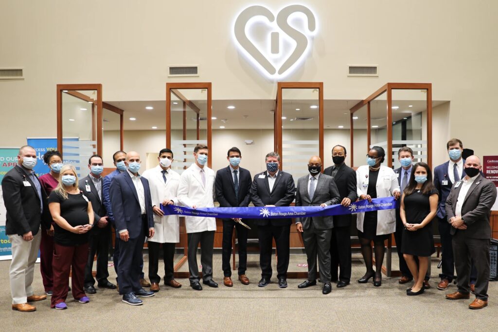 A group of doctors and business people cuts the ribbon at the new cardiovascular clinic in Baton Rouge
