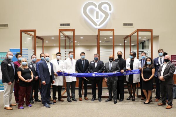 A group of doctors and business people cuts the ribbon at the new cardiovascular clinic in Baton Rouge