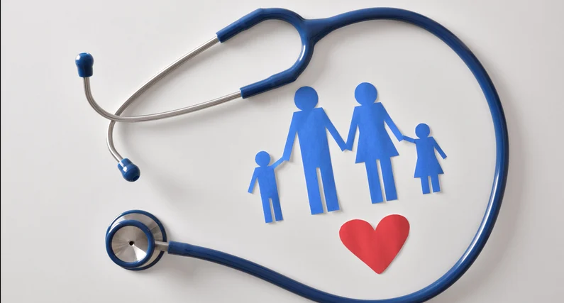 A stethoscope encircles a paper cutout of a family, symbolizing the care and protection cardiology provides to family wellbeing.