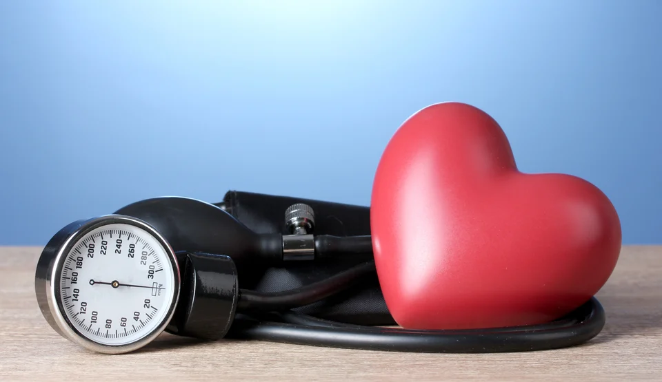 Monitoring the heartbeat of health: a sphygmomanometer and a red heart symbolize cardiology care and awareness.