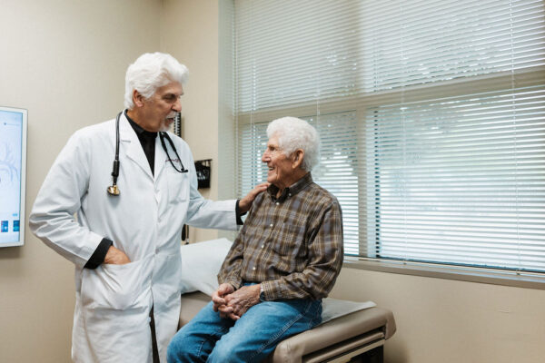 Dr. Peter Fail, CIS Cardiologist, consults with a patient in an exam room