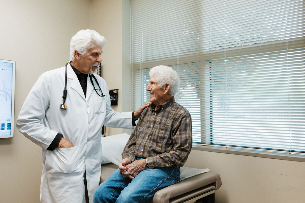 Dr. Peter Fail, CIS Cardiologist, consults with a patient in an exam room