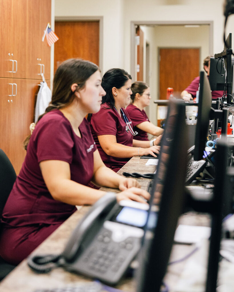 A busy nurses station at CIs, with several nurses working at computers