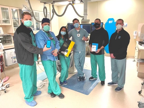 A group of CIS staff members pose with the Gallant™ Implantable Cardioverter-Defibrillator (ICD) bluetooth device