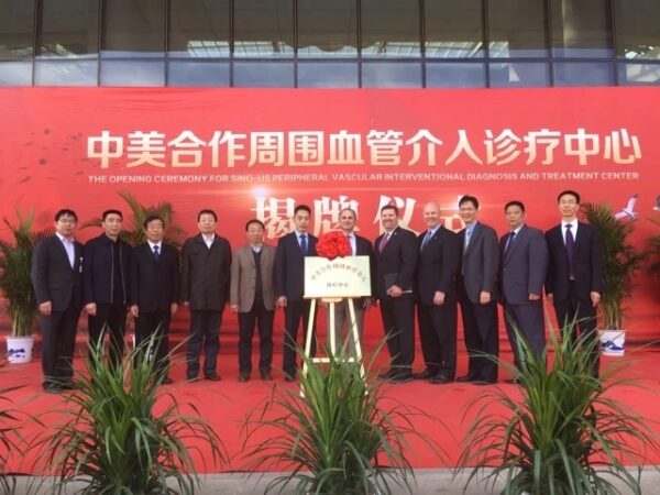 Group of individuals posing for a photo at the opening ceremony of a new medical center dedicated to peripheral vascular interventional diagnosis and treatment of venous disease.