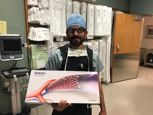 A surgeon holding a diagram of how the Venovo venous stent works