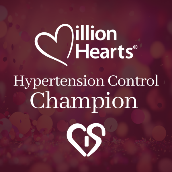The image features a bokeh background with shades of pink and purple, overlayed with white text that reads "hypertension control champion" and includes the "million hearts®" logo with a heart