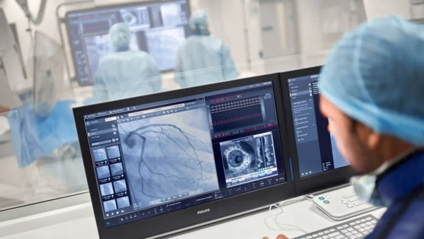 Medical professional analyzing heart health imaging on advanced monitor screens in a high-tech Cardiovascular Institute of the South environment.