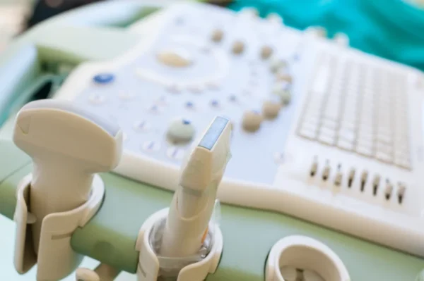 Close-up of an ultrasound machine with a transducer probe at the Cardiovascular Institute of the South, ready for diagnostic medical imaging in cardiology.