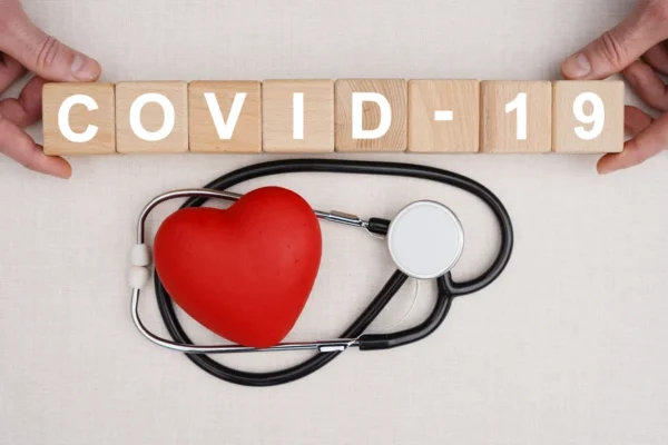 Healthcare professionals holding strong in the fight against covid-19, represented by a stethoscope and a heart symbolizing care and dedication to heart health.