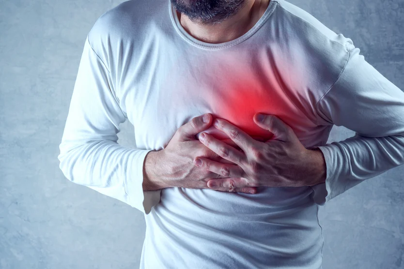 Man experiencing chest pain, possibly indicative of heartburn or cardiac distress, may need to consult a heart doctor at the Cardiovascular Institute of the South for thorough evaluation.