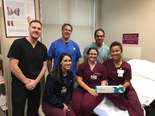 A group of happy-looking CIS staff poses with a box containing the new Varithena varicose vein treatment
