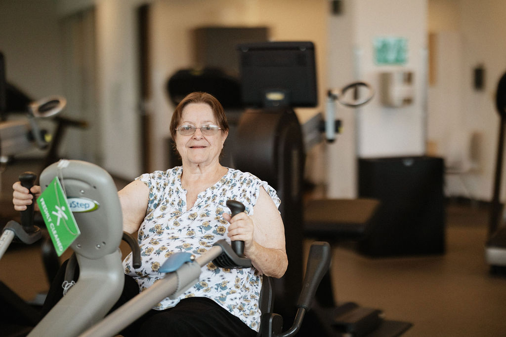 An older woman using recumbent exercise machine at Intensive Cardiac Rehab