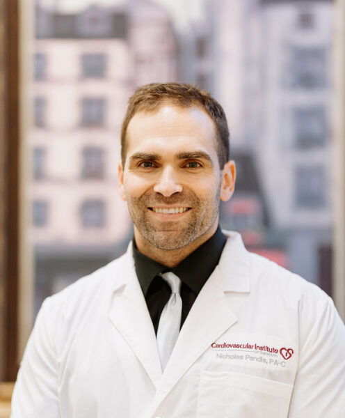 Confident healthcare professional in white lab coat with a friendly smile, standing in front of an out-of-focus cityscape background.