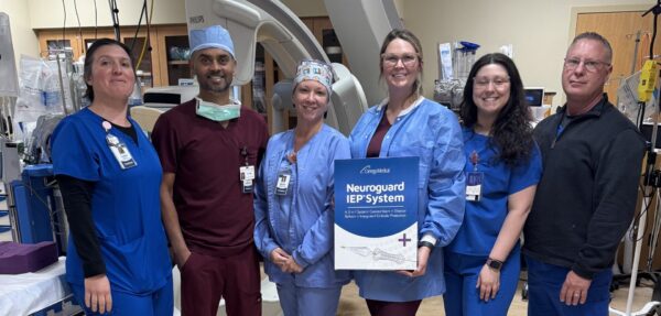 Six healthcare professionals stand together in a hospital room, one person holds a Neuoguard IEF 5 System box.