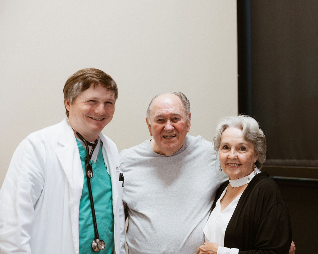 Group shot of vascular specialist with his patients, a husband and wife