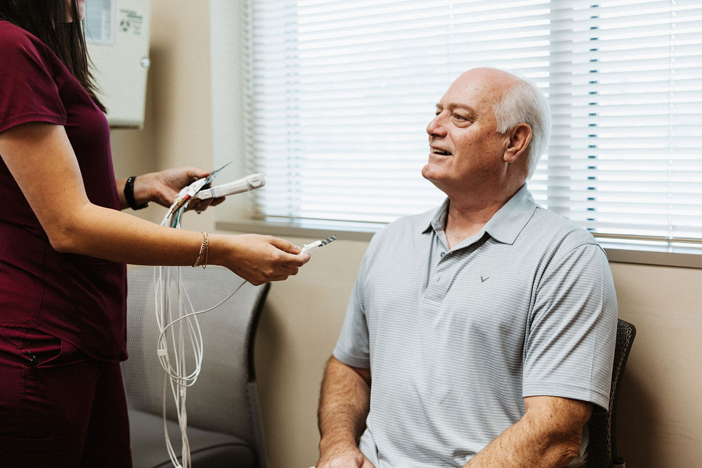 Elderly man consulting with nurse at cardiovascular appointment